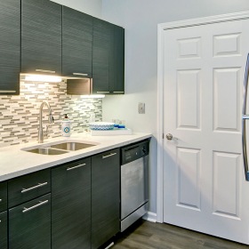 Kitchen kitchen area on wooden floor with spacious counter-space and designer appliances