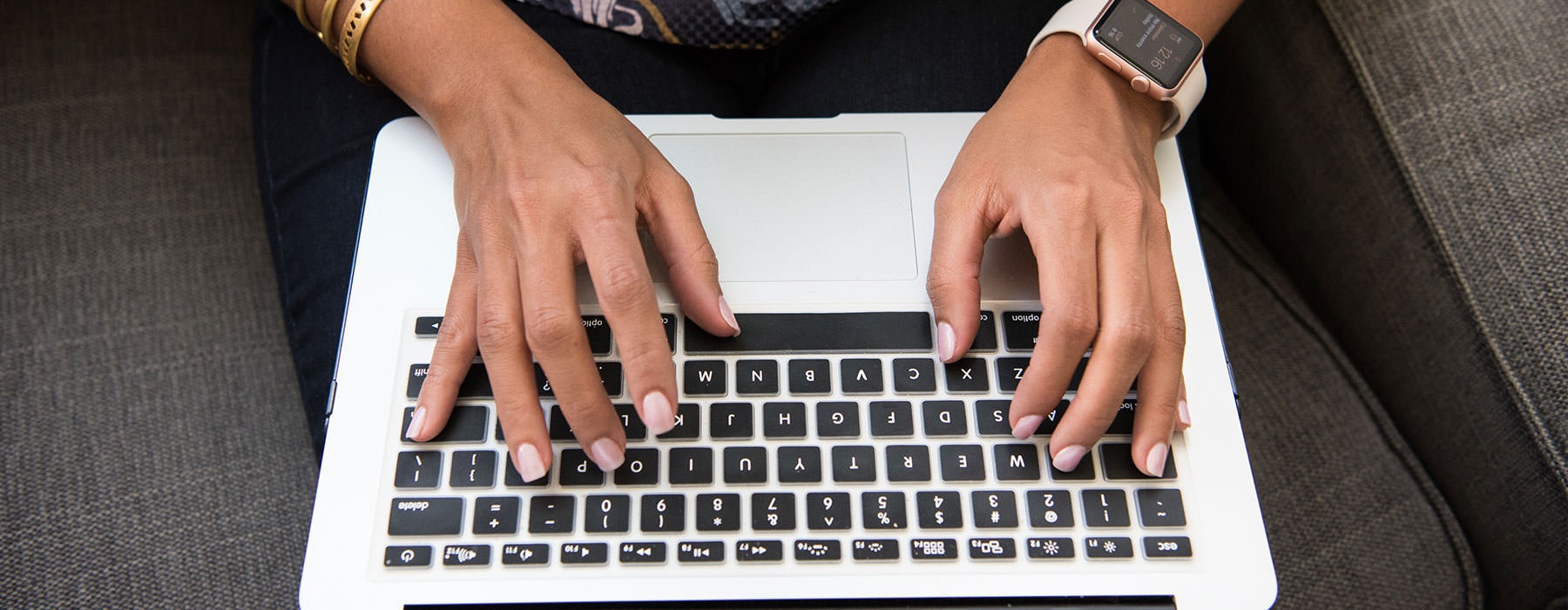 lifestyle image of a person typing on their laptop